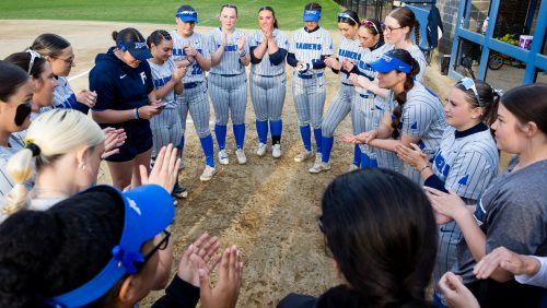 Rivier women's softball team huddle