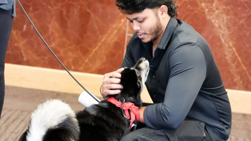 Rivier male student with a dog